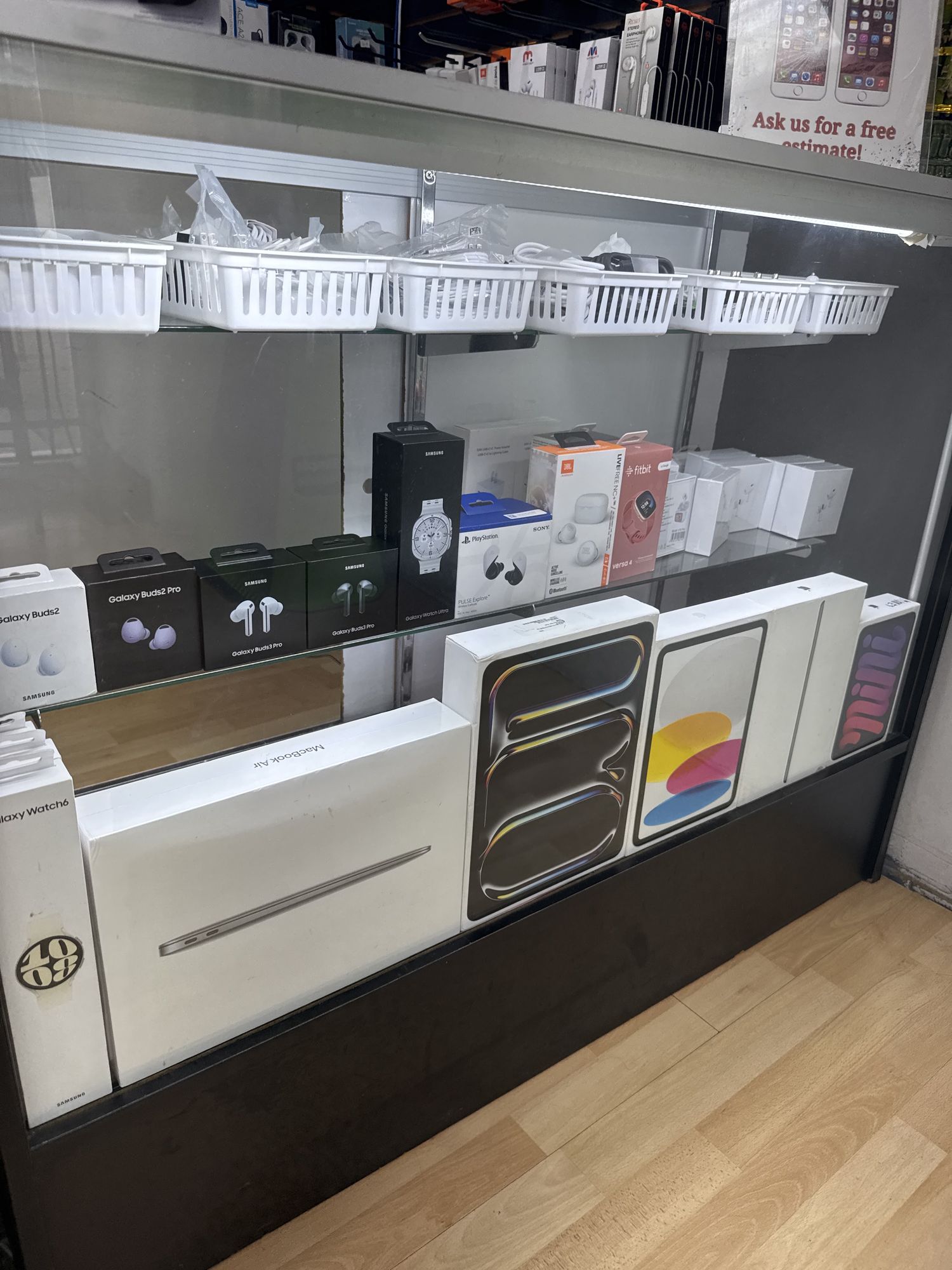Apple iPad, AirPods and accessories in a glass display