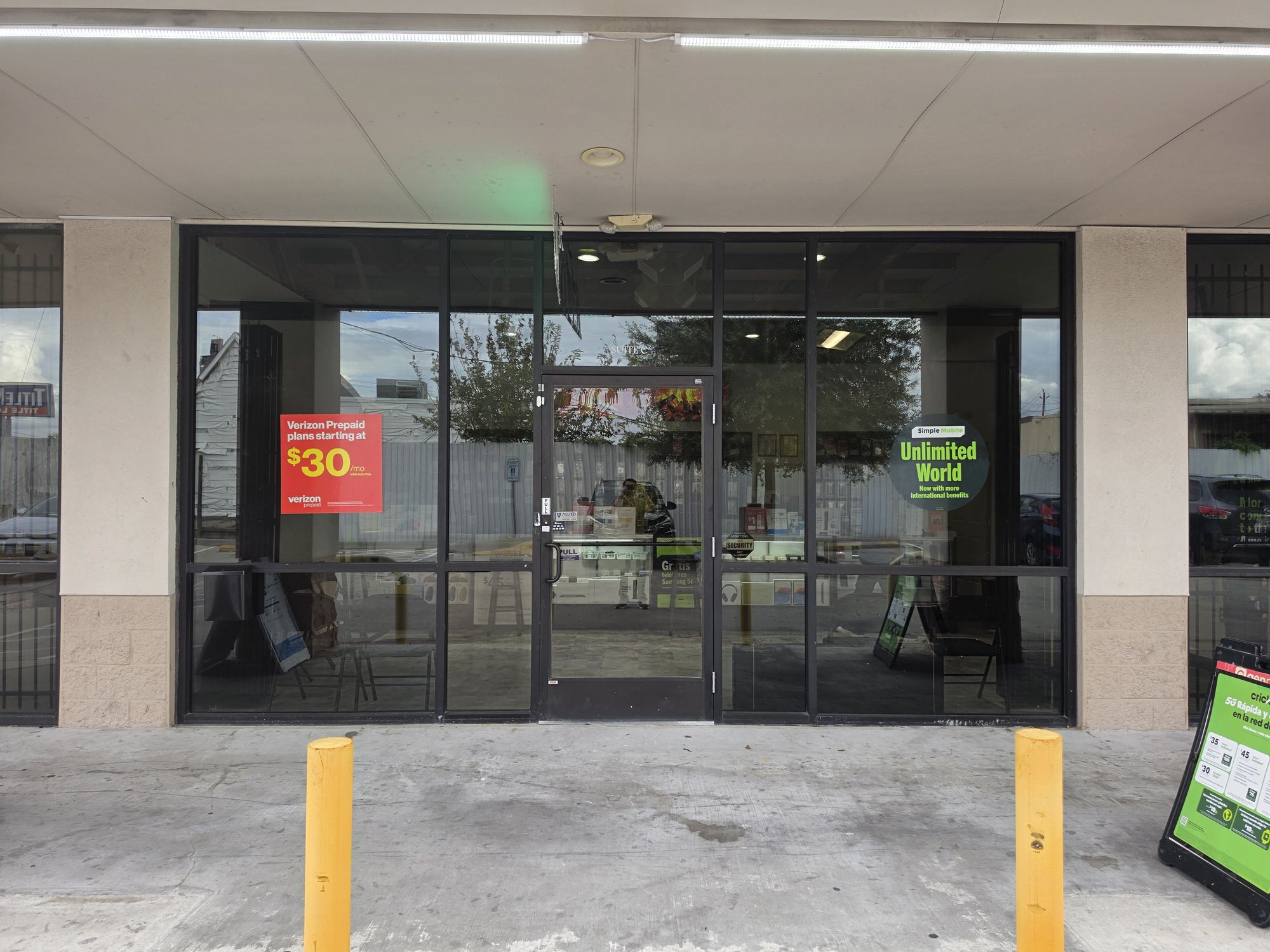 The glass storefront of the new TIC Wireless Electronic & Repair Center store at 3640 Hillcroft St, Suite C, Houston